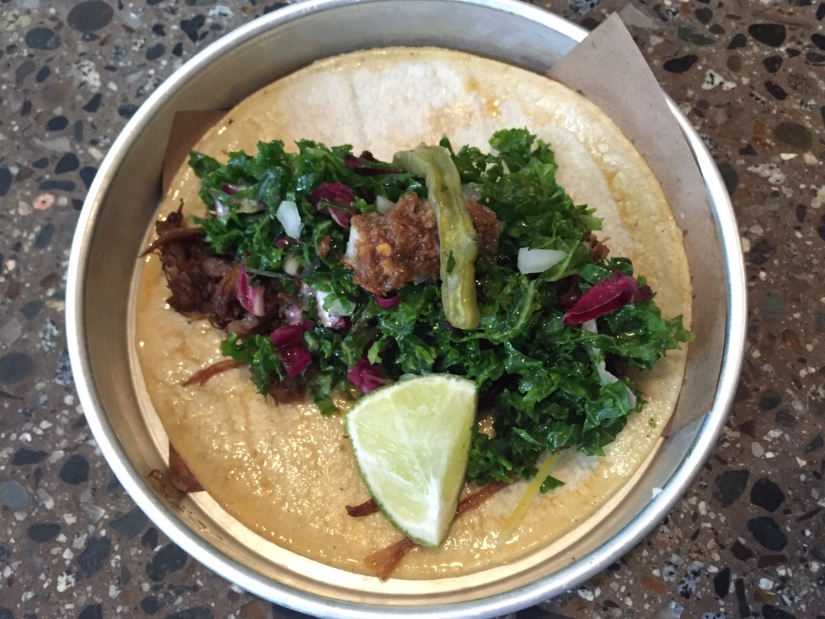 lamb birria taco - herb salad, arbol chili, pickled nopales, preserved lemon zest