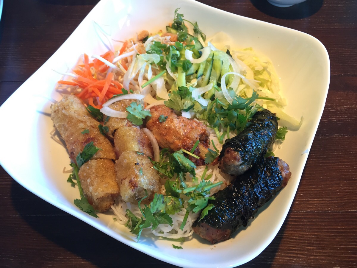 special vermicelli bowl with spring roll, sugar cane shrimp, and beef wrapped in betel leaf
