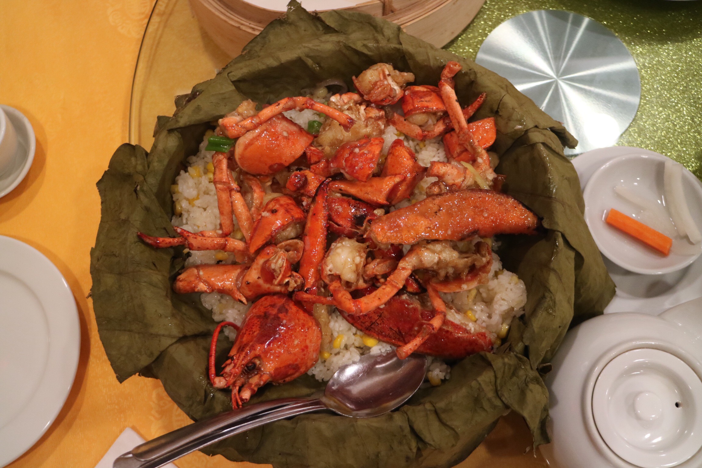 whole lobster and sticky rice on lotus leaf