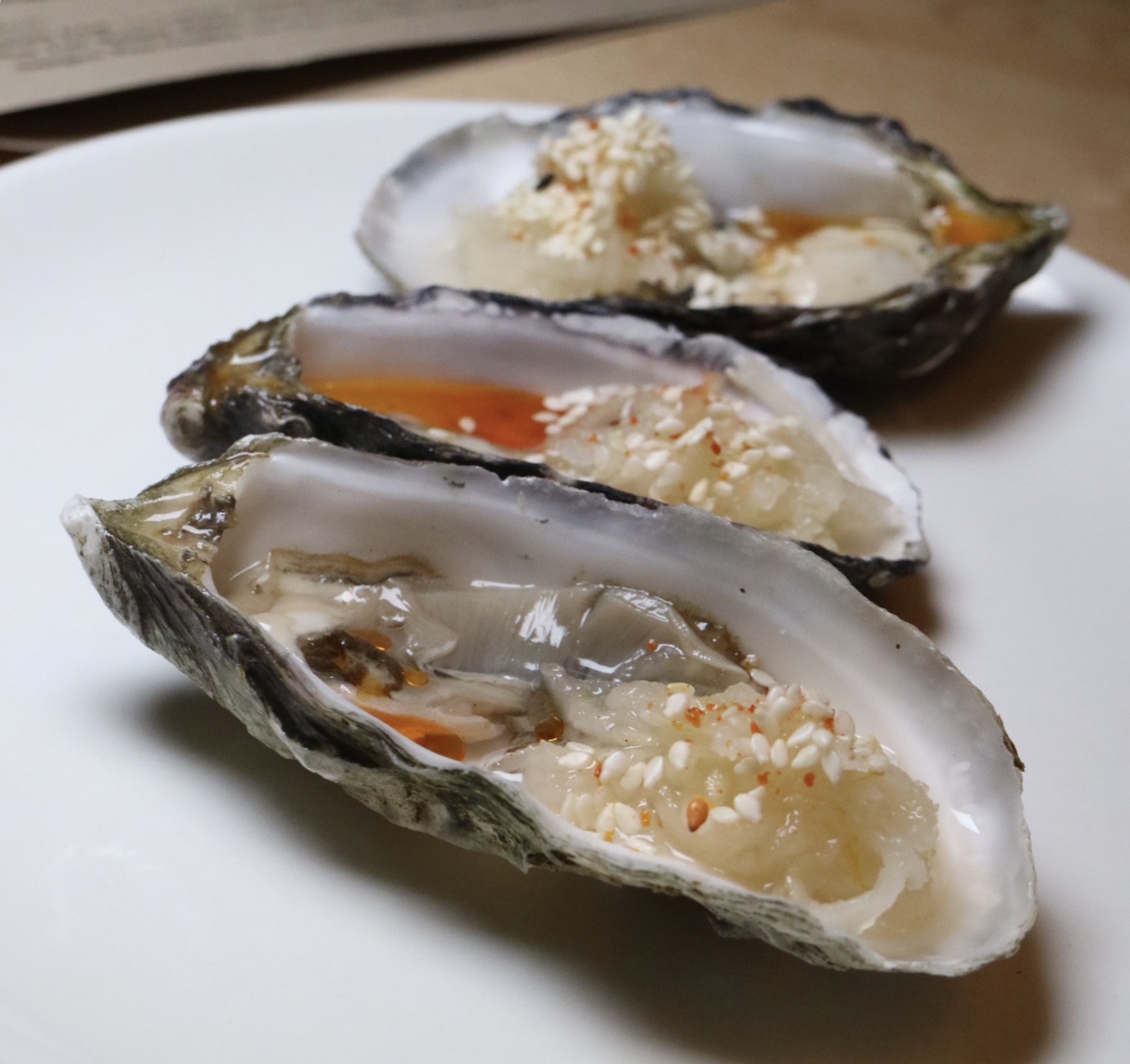 hog island sweetwater oysters with kohlrabi kraut & sesame
