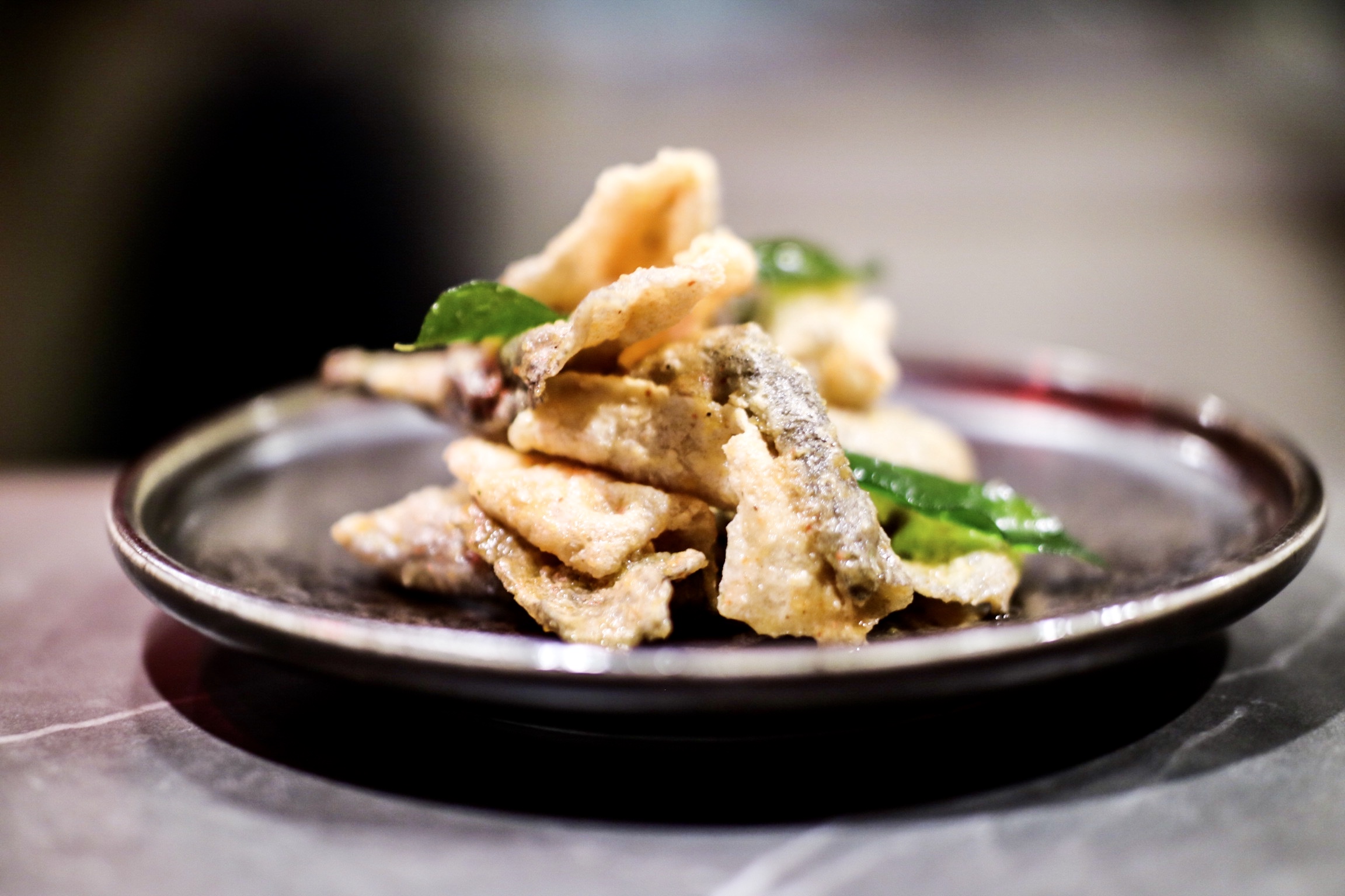 Crispy fish skin with duck egg-yolk